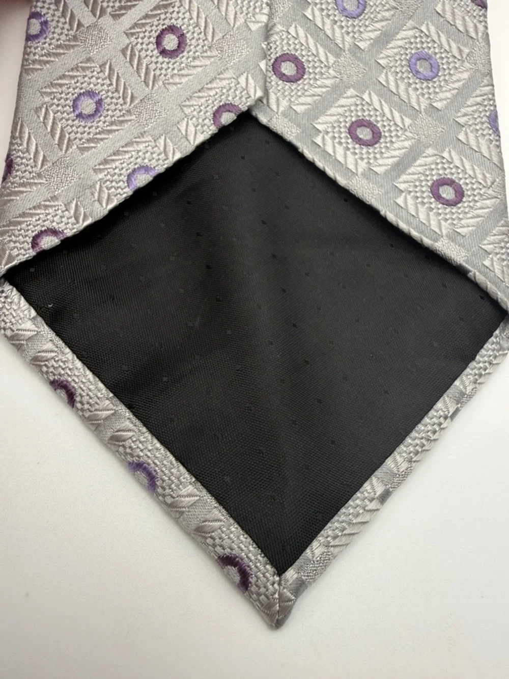 Pierre Cardin tie in a silver and purple geometric pattern. 100% silk.